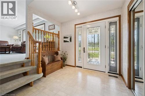 Foyer featuring a decorative glass front door with coordinating sidelights, light-toned tiled flooring, and a mirrored closet - 18 Strathcona Crescent, Kitchener, ON - Indoor Photo Showing Other Room