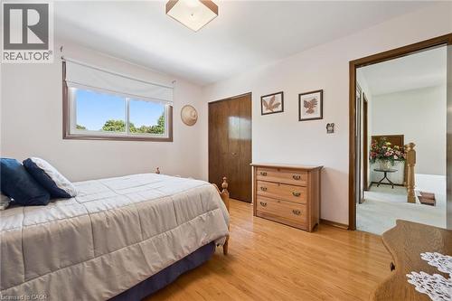 Spacious bedroom featuring hardwood flooring and large window with natural light. - 18 Strathcona Crescent, Kitchener, ON - Indoor Photo Showing Bedroom