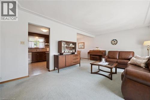 Spacious living area featuring light-toned carpeting and white walls - 18 Strathcona Crescent, Kitchener, ON - Indoor Photo Showing Living Room