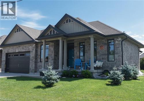 Contemporary stone exterior with architectural gable detailing and multiple roof peaks - 10 Craddock Boulevard, Jarvis, ON - Outdoor With Facade