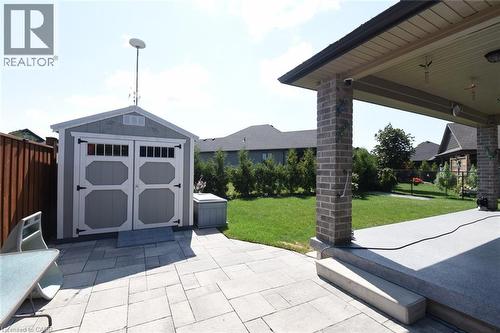 Exterior patio featuring a covered area with brick columns and a separate storage shed - 10 Craddock Boulevard, Jarvis, ON - Outdoor With Deck Patio Veranda
