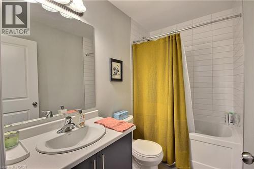 Full bathroom featuring a single vanity with storage, a rectangular mirror, and a shower-tub combination with white subway tile surround - 287 Chapel Hill Drive, Kitchener, ON - Indoor Photo Showing Bathroom