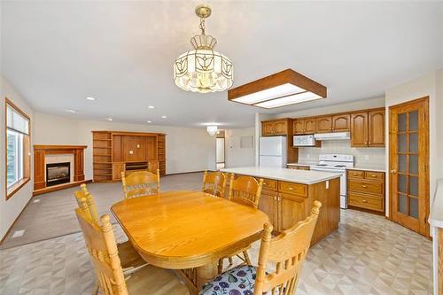 149 Bridgeview Dr, St Clements, MB - Indoor Photo Showing Dining Room With Fireplace