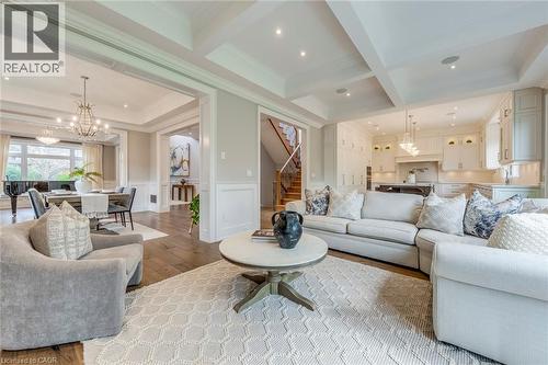 Open-concept living area featuring rich wood-finish flooring, a coffered ceiling, and recessed lighting - 436 Willis Drive, Oakville, ON - Indoor Photo Showing Living Room