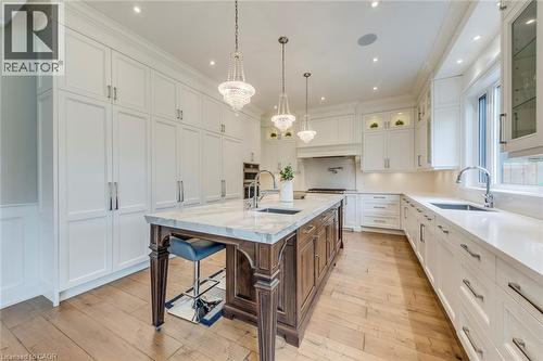 Gourmet kitchen featuring a substantial wood-finish island with a stone countertop, integrated sink, and pendant lighting - 436 Willis Drive, Oakville, ON - Indoor Photo Showing Kitchen With Upgraded Kitchen