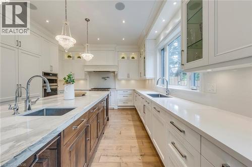 Gourmet kitchen featuring a substantial island with an integrated sink and light-toned, veined countertop - 436 Willis Drive, Oakville, ON - Indoor Photo Showing Kitchen With Upgraded Kitchen