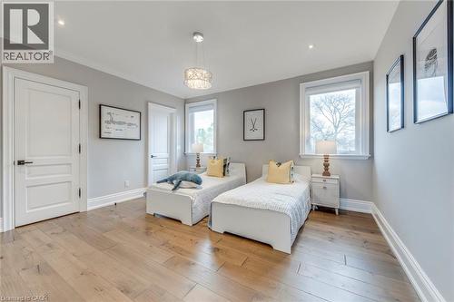 Bedroom featuring wide plank wood-finish flooring, light grey wall paint, and white trim - 436 Willis Drive, Oakville, ON - Indoor Photo Showing Bedroom