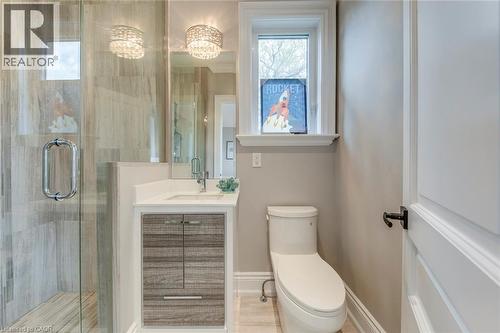 Walk-in shower with clear glass enclosure and wood-finish tile - 436 Willis Drive, Oakville, ON - Indoor Photo Showing Bathroom