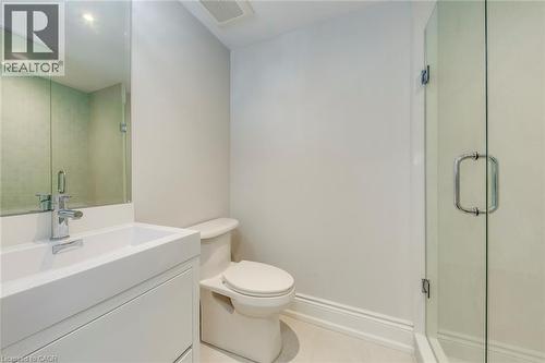 Bathroom featuring a frameless glass shower enclosure, a contemporary white floating vanity with an integrated sink, a chrome single-handle faucet, and an overhead recessed light - 436 Willis Drive, Oakville, ON - Indoor Photo Showing Bathroom