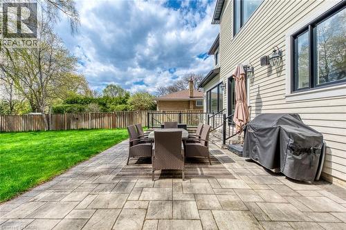 Expansive outdoor patio featuring rectangular pavers, a manicured lawn, and a privacy fence - 436 Willis Drive, Oakville, ON - Outdoor With Exterior