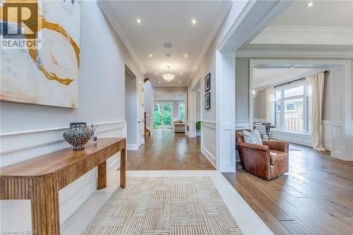 Spacious entryway featuring light wood-finish flooring, recessed lighting, crown molding, and wainscoting - 436 Willis Drive, Oakville, ON - Indoor Photo Showing Other Room
