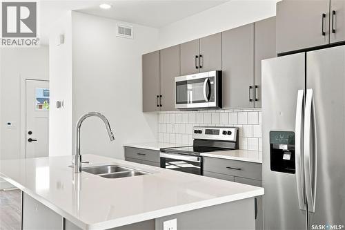 115 Rosewood Boulevard E, Saskatoon, SK - Indoor Photo Showing Kitchen With Stainless Steel Kitchen With Double Sink With Upgraded Kitchen