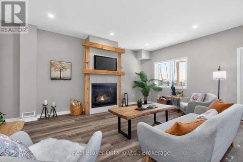 90 14 Concession E, Tiny, ON - Indoor Photo Showing Living Room With Fireplace