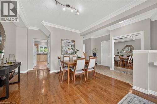 Dining space featuring wood-finish flooring, crown molding, and track lighting - 24 Knack Lane, Cambridge, ON - Indoor Photo Showing Dining Room