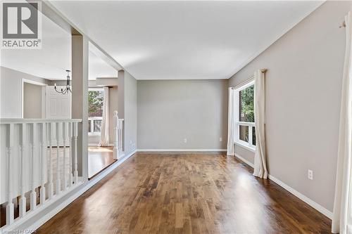 Spacious room featuring wood-finish flooring, neutral wall tones, and white trim - 129 Kovac Road, Cambridge, ON - Indoor Photo Showing Other Room