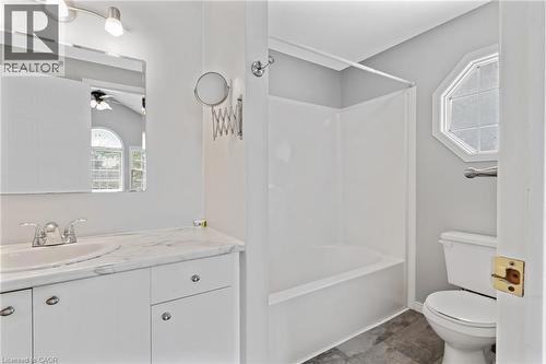 Bathroom featuring a white vanity with a marble-finish countertop, undermount sink, and chrome faucet - 129 Kovac Road, Cambridge, ON - Indoor Photo Showing Bathroom