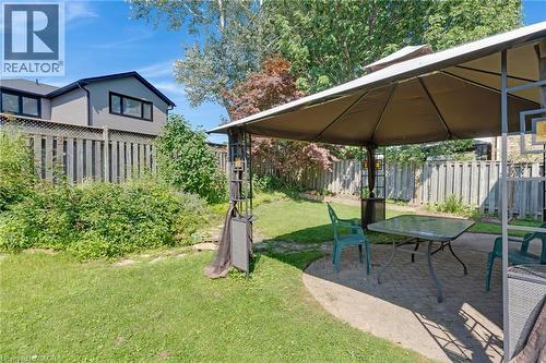 Outdoor patio featuring paver stones, a covered gazebo structure, and a perimeter fence - 129 Kovac Road, Cambridge, ON - Outdoor