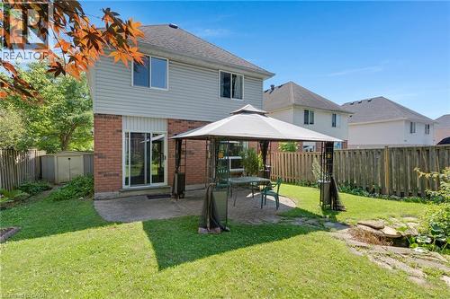 Fenced backyard featuring a patio, a small pond, and a storage shed - 129 Kovac Road, Cambridge, ON - Outdoor