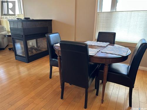 205 75 Souris Avenue, Weyburn, SK - Indoor Photo Showing Dining Room With Fireplace