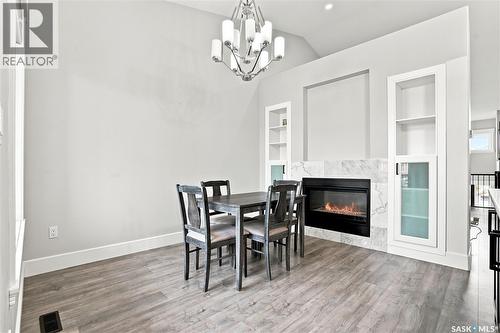 670 Fast Crescent, Saskatoon, SK - Indoor Photo Showing Dining Room With Fireplace