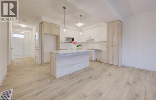 Open-concept kitchen and living area featuring wood-finish flooring - 89 Rivergreen Crescent, Cambridge, ON - Indoor Photo Showing Kitchen