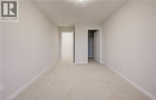 Carpeted room with light neutral wall paint - 89 Rivergreen Crescent, Cambridge, ON - Indoor Photo Showing Other Room