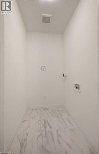 Dedicated utility space featuring white walls and marble-look tile flooring - 89 Rivergreen Crescent, Cambridge, ON - Indoor Photo Showing Other Room