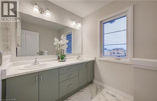 Dual vanity with undermount sinks and light gray cabinetry, complemented by a large wall-mounted mirror - 89 Rivergreen Crescent, Cambridge, ON - Indoor Photo Showing Bathroom