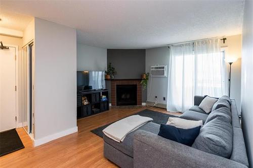 1107-650 Kenaston Blvd, Winnipeg, MB - Indoor Photo Showing Living Room With Fireplace