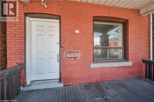 Welcoming front entrance featuring a solid six-panel white entry door with sidelights, situated on a composite deck with clean lines - 334 Cannon Street E, Hamilton, ON - Outdoor With Exterior