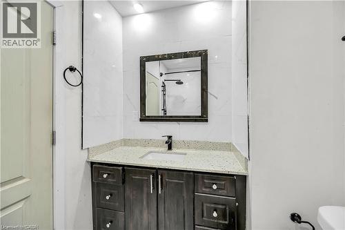 Contemporary vanity with a light speckled countertop and undermount sink - 334 Cannon Street E, Hamilton, ON - Indoor Photo Showing Bathroom