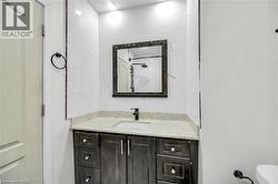 Contemporary vanity with a light speckled countertop and undermount sink - 