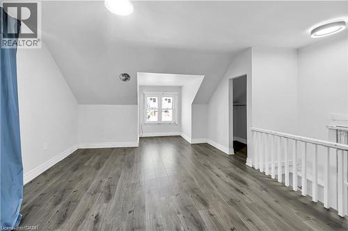 Spacious room featuring wood-finish flooring, white baseboards, and bright white walls - 334 Cannon Street E, Hamilton, ON - Indoor Photo Showing Other Room