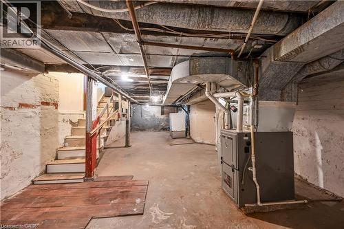 Utility space featuring exposed brick foundation, concrete flooring, and visible overhead ductwork - 334 Cannon Street E, Hamilton, ON - Indoor Photo Showing Basement