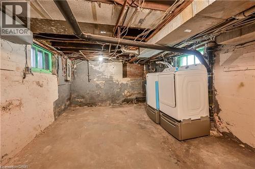 Basement space featuring exposed structural beams, a concrete floor, and painted block walls - 334 Cannon Street E, Hamilton, ON - Indoor Photo Showing Basement