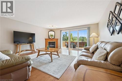 Gas fireplace, hardwood flooring and walkout to deck. - 187 Westchester Drive, Kitchener, ON - Indoor Photo Showing Living Room With Fireplace