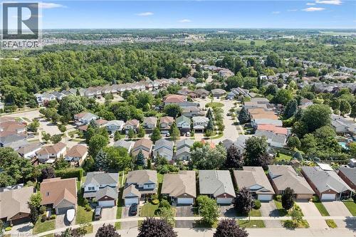 Residential neighborhood setting featuring multiple single-family homes, mature landscaping, paved streets, and a distant treeline - 187 Westchester Drive, Kitchener, ON - Outdoor With View