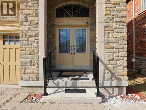 Stone veneer facade with prominent columns framing the main entry - 584 Pinery Trail, Waterloo, ON - Outdoor