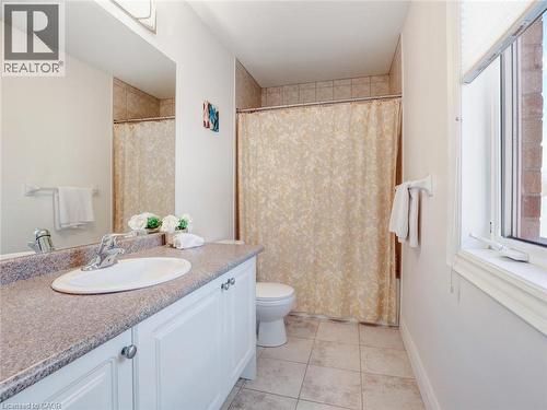 Full bathroom featuring a single vanity with a laminate countertop, white cabinetry, and an oval undermount sink - 584 Pinery Trail, Waterloo, ON - Indoor Photo Showing Bathroom