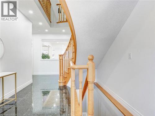 Curved natural wood staircase with balusters and handrail - 584 Pinery Trail, Waterloo, ON - Indoor Photo Showing Other Room