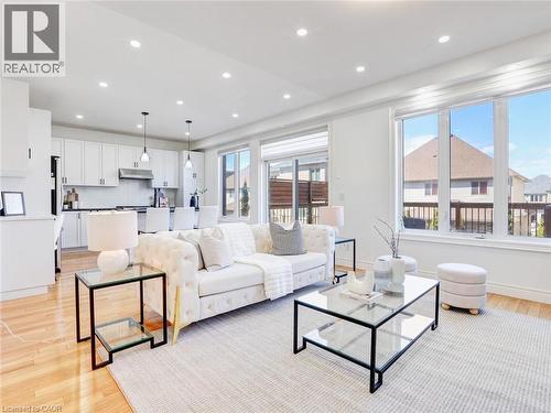 Open-concept living area featuring recessed lighting and wood-finish flooring - 584 Pinery Trail, Waterloo, ON - Indoor Photo Showing Living Room