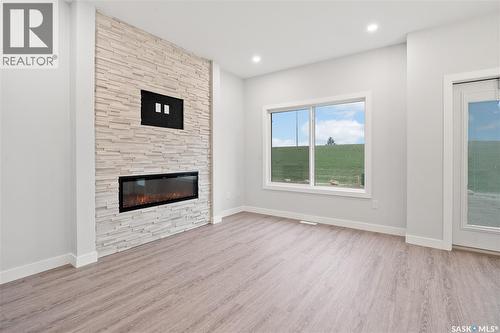 2921 Green Turtle Road, Regina, SK - Indoor Photo Showing Living Room With Fireplace