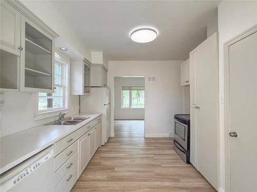 Galley Kitchen - 534 20Th Street, Brandon, MB - Indoor Photo Showing Kitchen With Double Sink