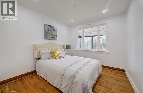 Hardwood flooring, white walls, recessed lighting, and a multi-pane window - 182 Avalon Place, Kitchener, ON - Indoor Photo Showing Bedroom