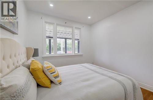 Room featuring white walls, recessed ceiling lighting, and wood-finish flooring - 182 Avalon Place, Kitchener, ON - Indoor Photo Showing Bedroom