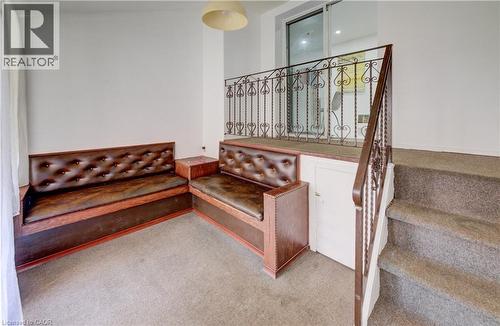 Carpeted staircase with an ornate wrought iron railing - 182 Avalon Place, Kitchener, ON - Indoor Photo Showing Other Room