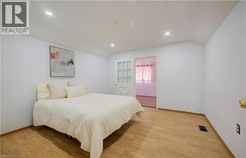 Spacious room featuring wood-finish flooring, recessed lighting, and white wall finishes - 182 Avalon Place, Kitchener, ON - Indoor Photo Showing Bedroom