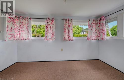 Bright room featuring multiple windows, white painted walls, and light-colored carpet flooring - 182 Avalon Place, Kitchener, ON - Indoor Photo Showing Other Room