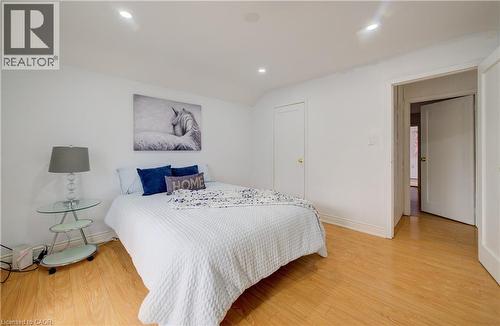 Bedroom featuring light wood-finish flooring, recessed lighting, and a white interior door - 182 Avalon Place, Kitchener, ON - Indoor Photo Showing Bedroom