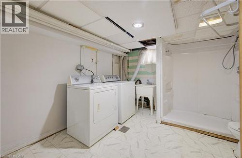 Utility area with white appliances, a freestanding basin sink, and a shower stall - 182 Avalon Place, Kitchener, ON - Indoor Photo Showing Laundry Room